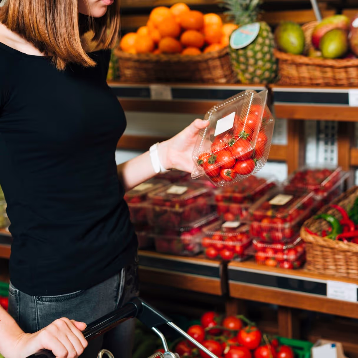 a customer buying tomatoes in the supermarket