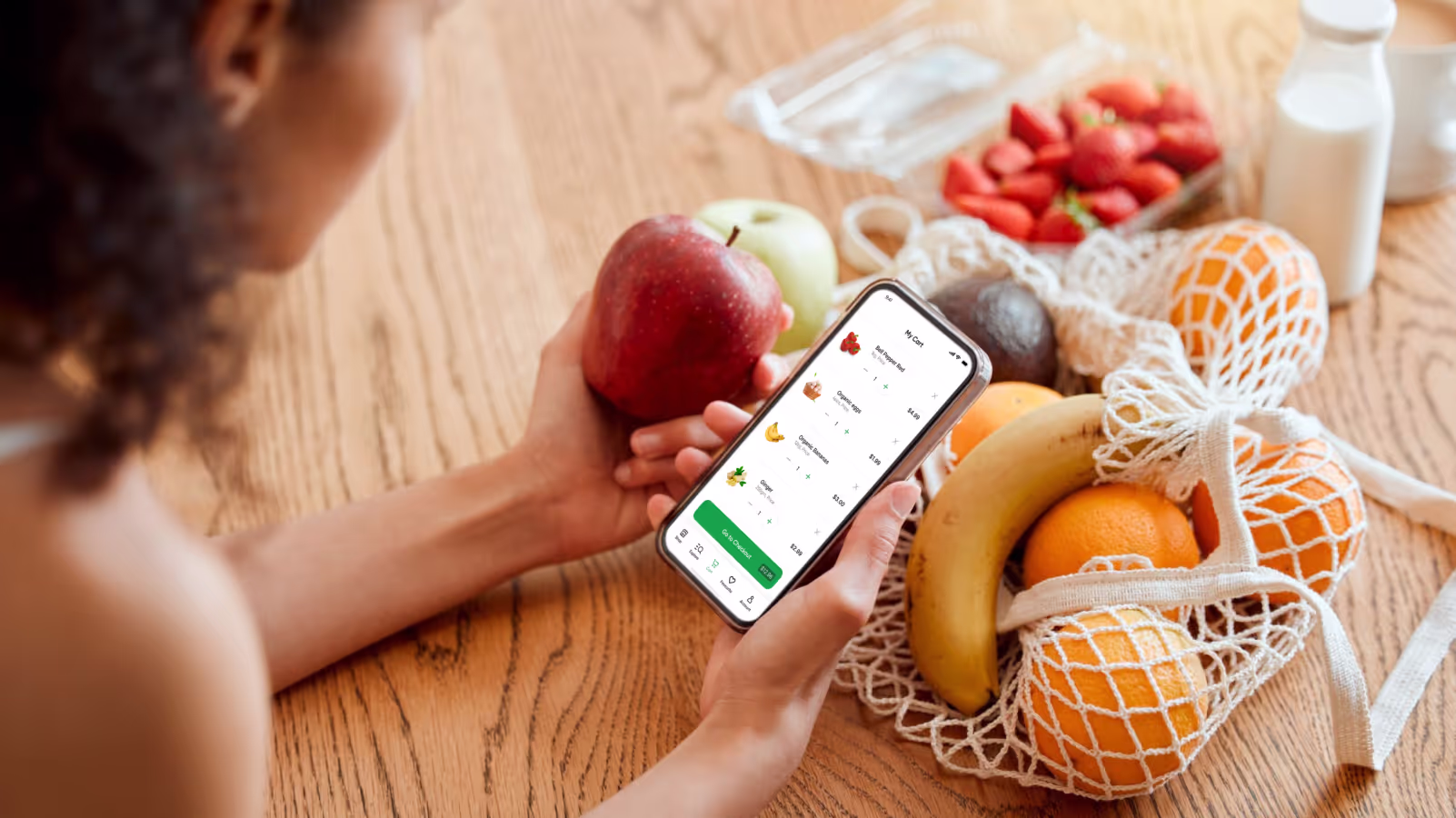 a woman ordering groceries online on her mobile phone
